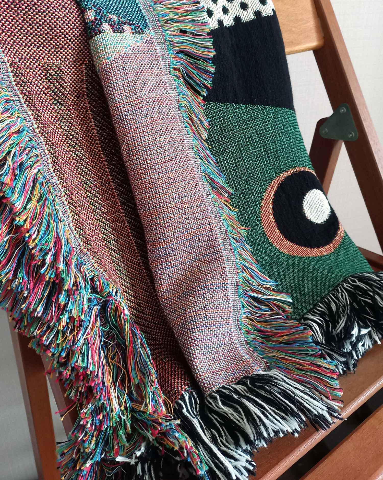 Checkered Birds Throw Blanket closeup over a chair