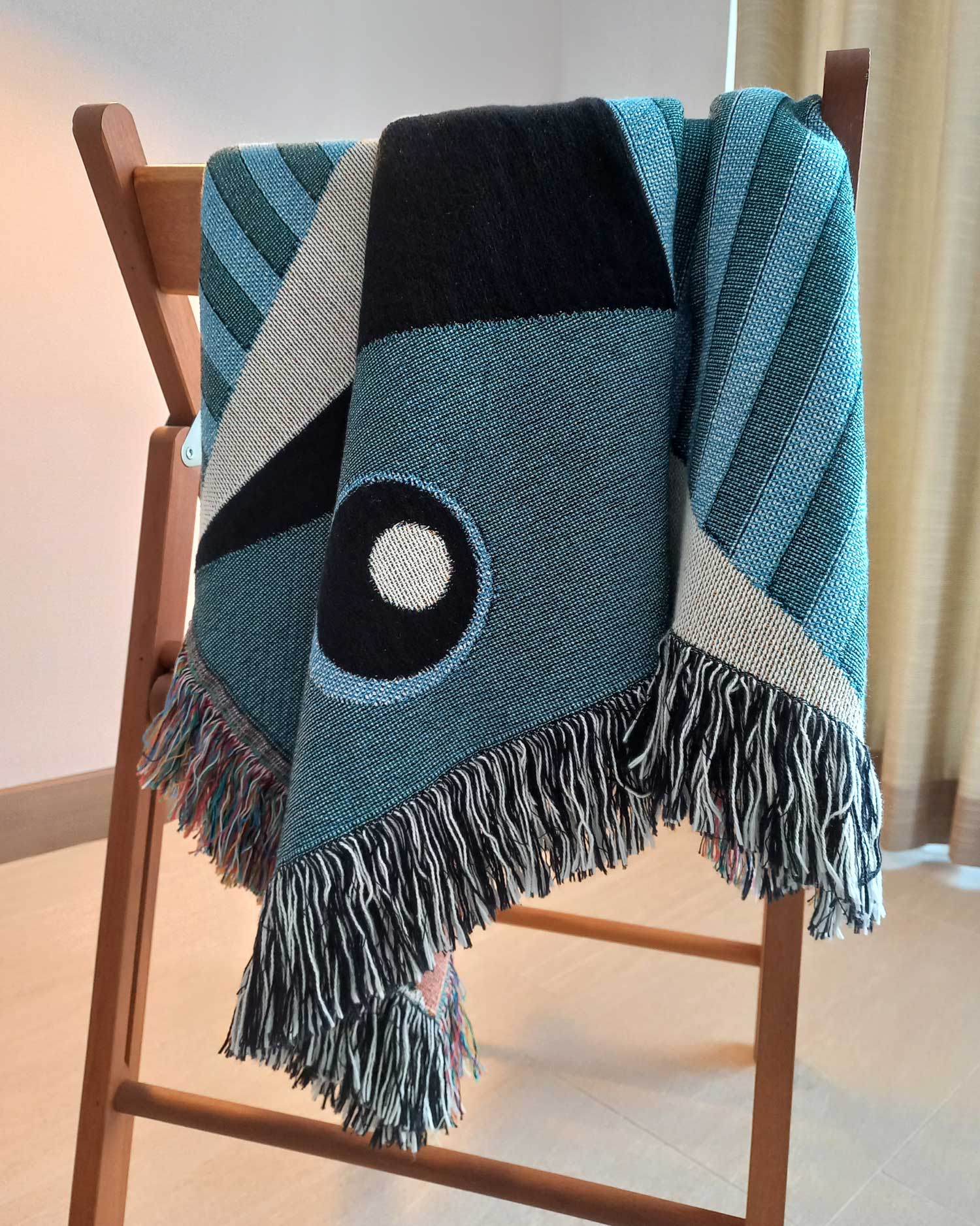 Geometric Throw Blanket hanging over a chair