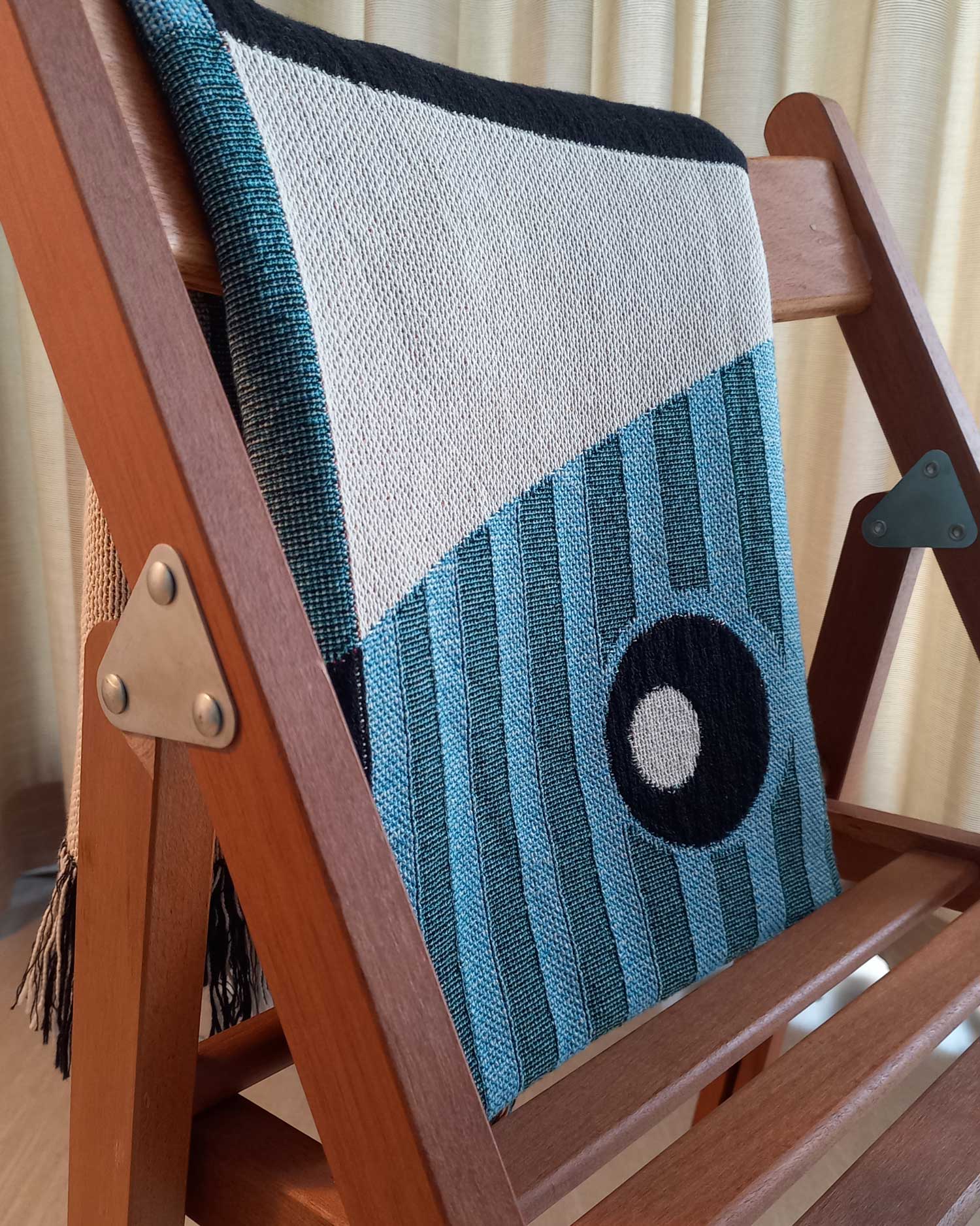Geometric Throw Blanket folded over a chair